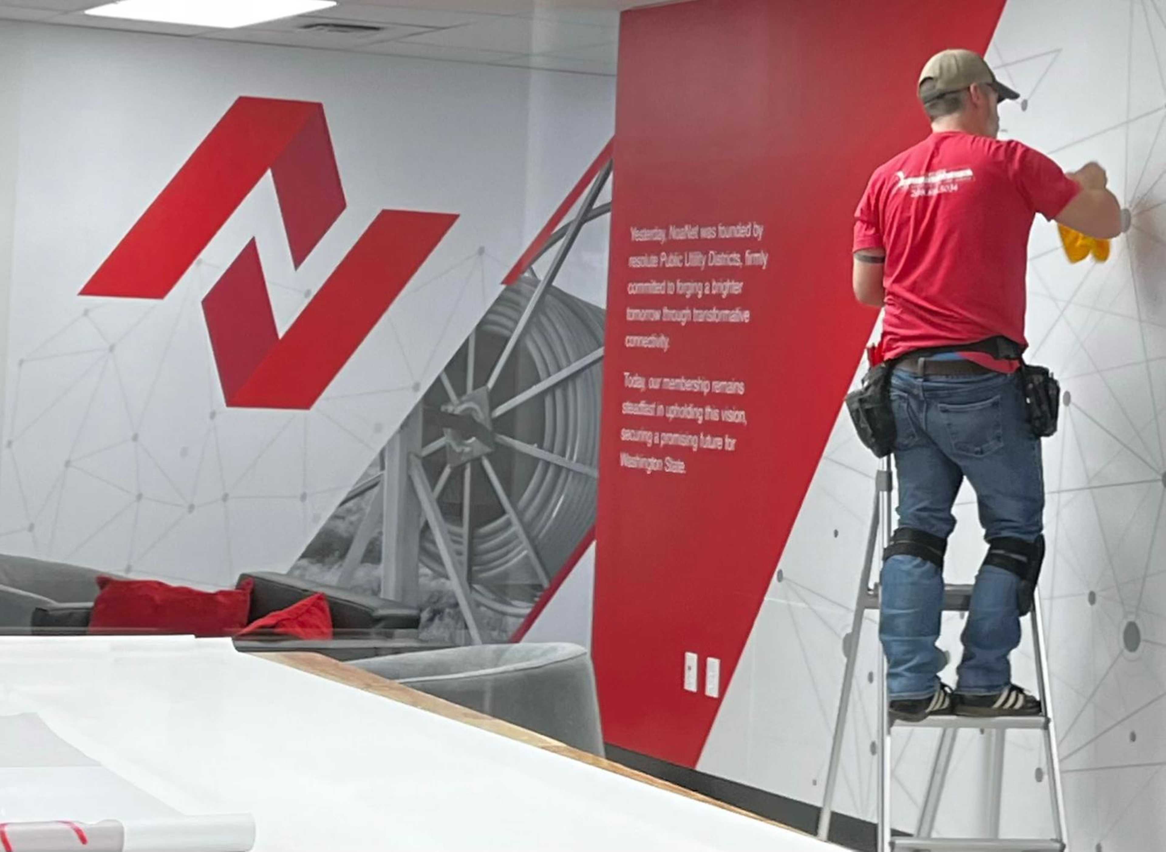 person placing wallcover on a office