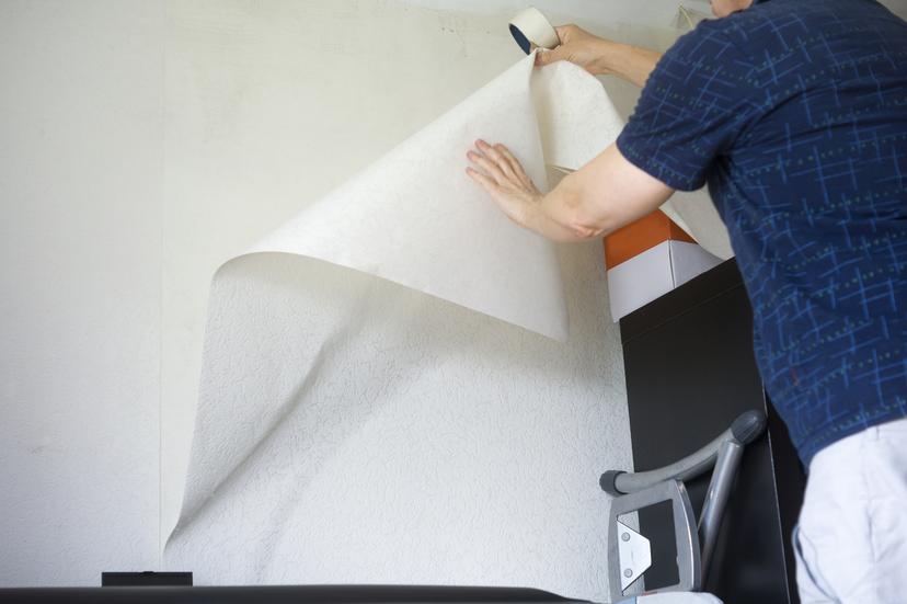 a person doing a removal of wall covering